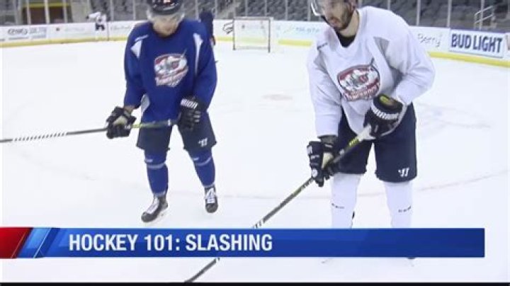 What is slashing in floor hockey?