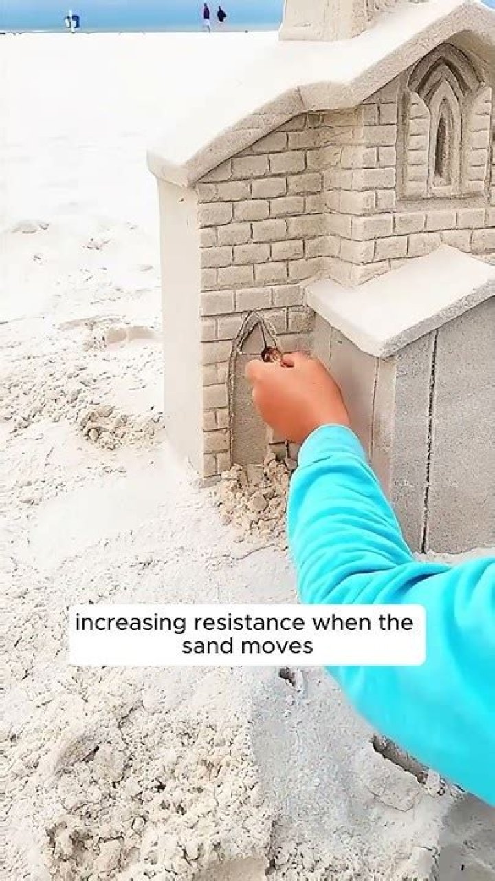Why does wet sand stick together?